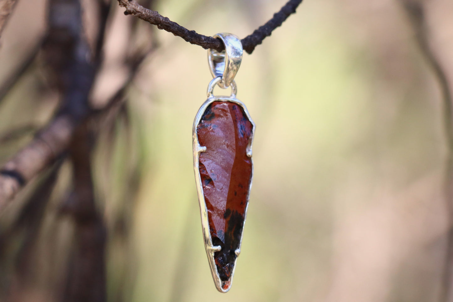 Mahogany Obsidian jewelry for Root Chakra support. Raw crystal pendant design showing the sharp, powerful shape for cutting energetic cords.