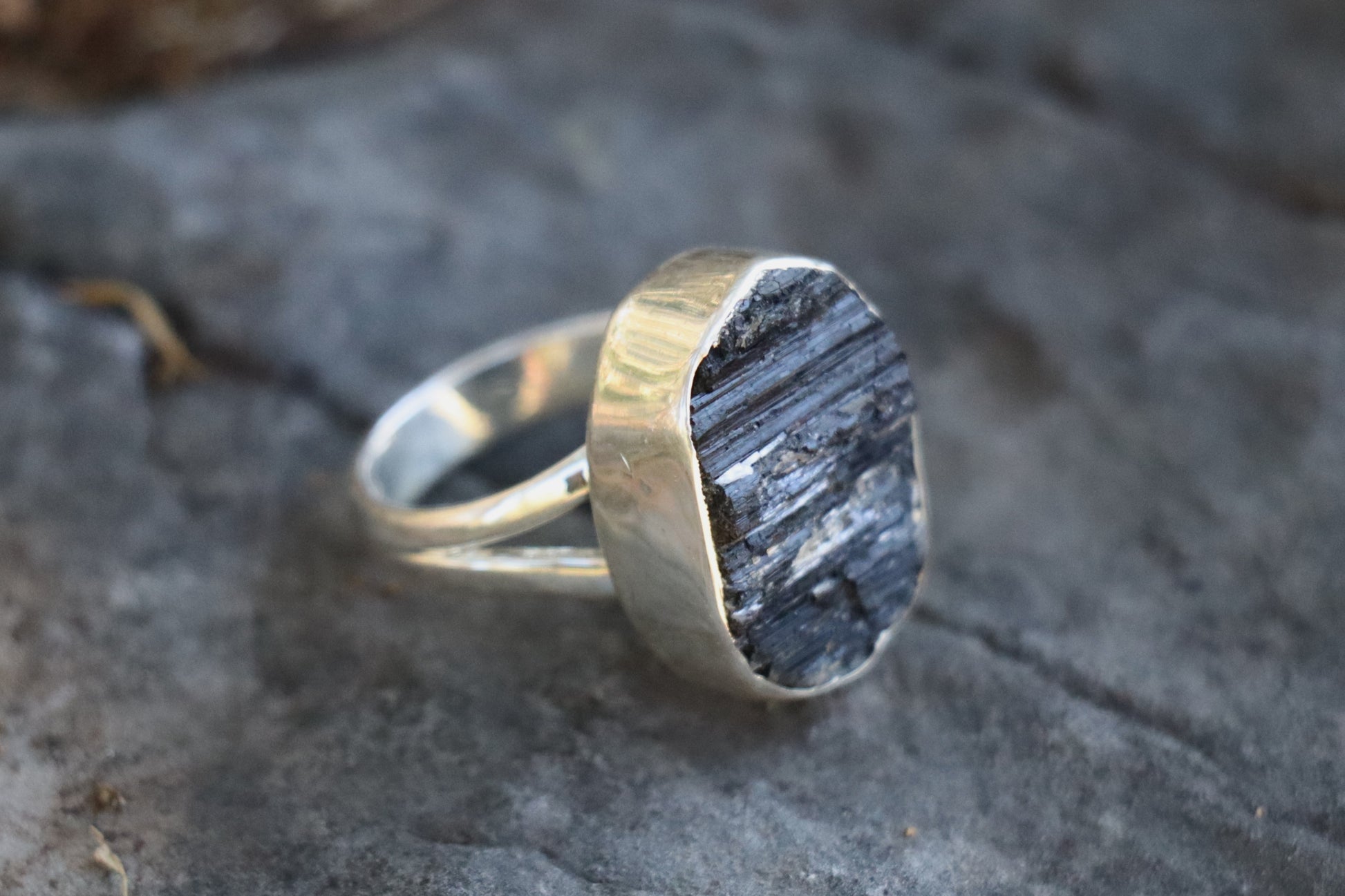 Black Tourmaline statement ring showing the left sife of the raw crystal texture. Saturn Pluto jewelry for Shadow Work and boundaries.