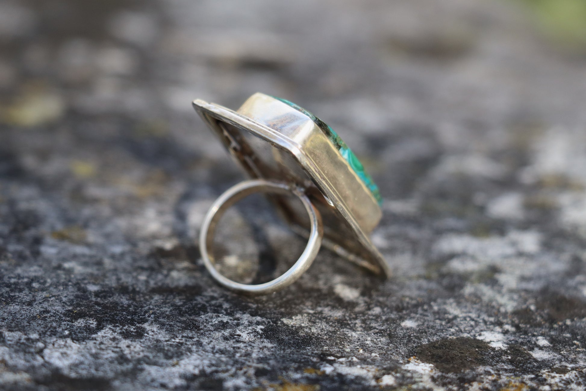 Side view of the Chrysocolla Malachite statement ring, showing the silver band and raised bezel setting. Handmade sterling silver crystal ring with a large natural stone.
