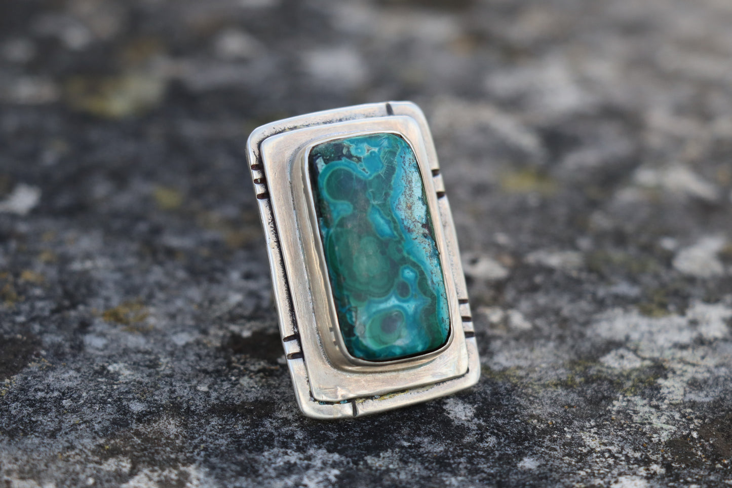 Angled close-up of a Chrysocolla Malachite gemstone ring in 925 silver, displaying the rich texture and natural mineral patterns. Artisan-crafted heart chakra jewelry.