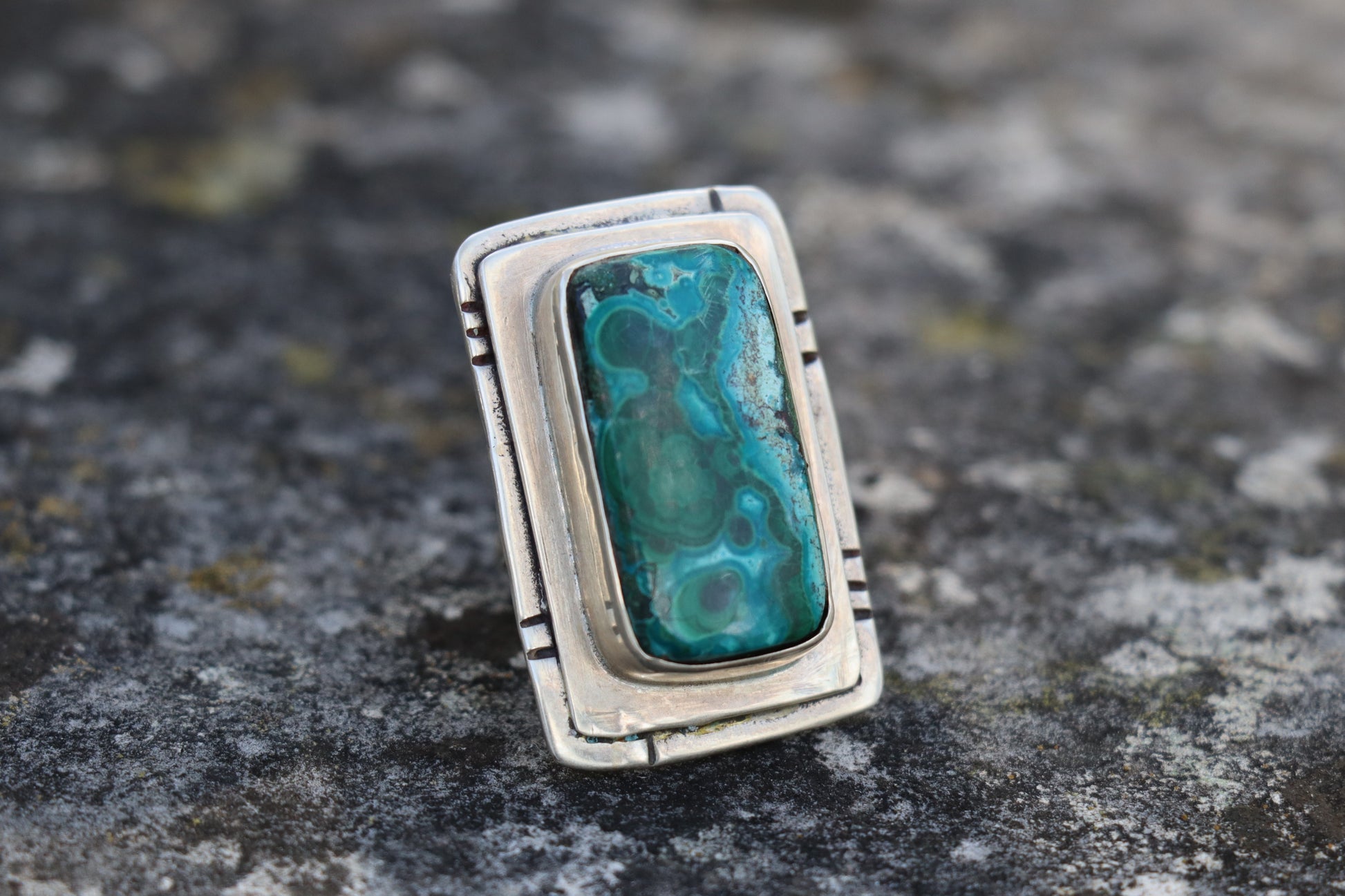 Angled close-up of a Chrysocolla Malachite gemstone ring in 925 silver, displaying the rich texture and natural mineral patterns. Artisan-crafted heart chakra jewelry.