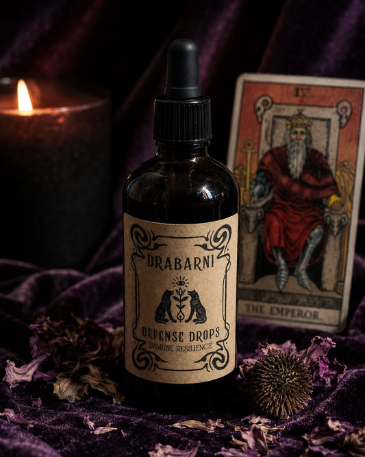 Defense Drops herbal immune support tincture on a mystical purple velvet ritual altar. The vintage kraft paper label details respiratory defense against sinus congestion, mucus, and sore throat. Infused with organic echinacea purpurea, wild Greek thyme, propolis, and elderberry flower.