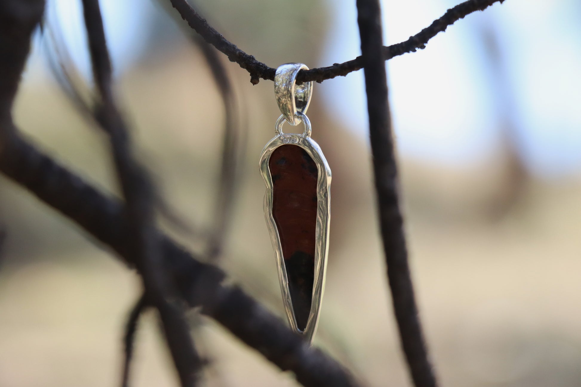 Back detail of the 925 Sterling Silver setting and the raw edge of the Mahogany Obsidian crystal. Emotional resilience tool.