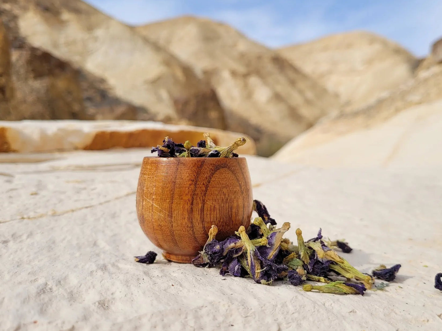 Organic Butterfly Pea tea flowers in a wooden cup, dried Clitoria ternatea used for calming tea, nervous system support, lunar herbal rituals, and astroherbalism