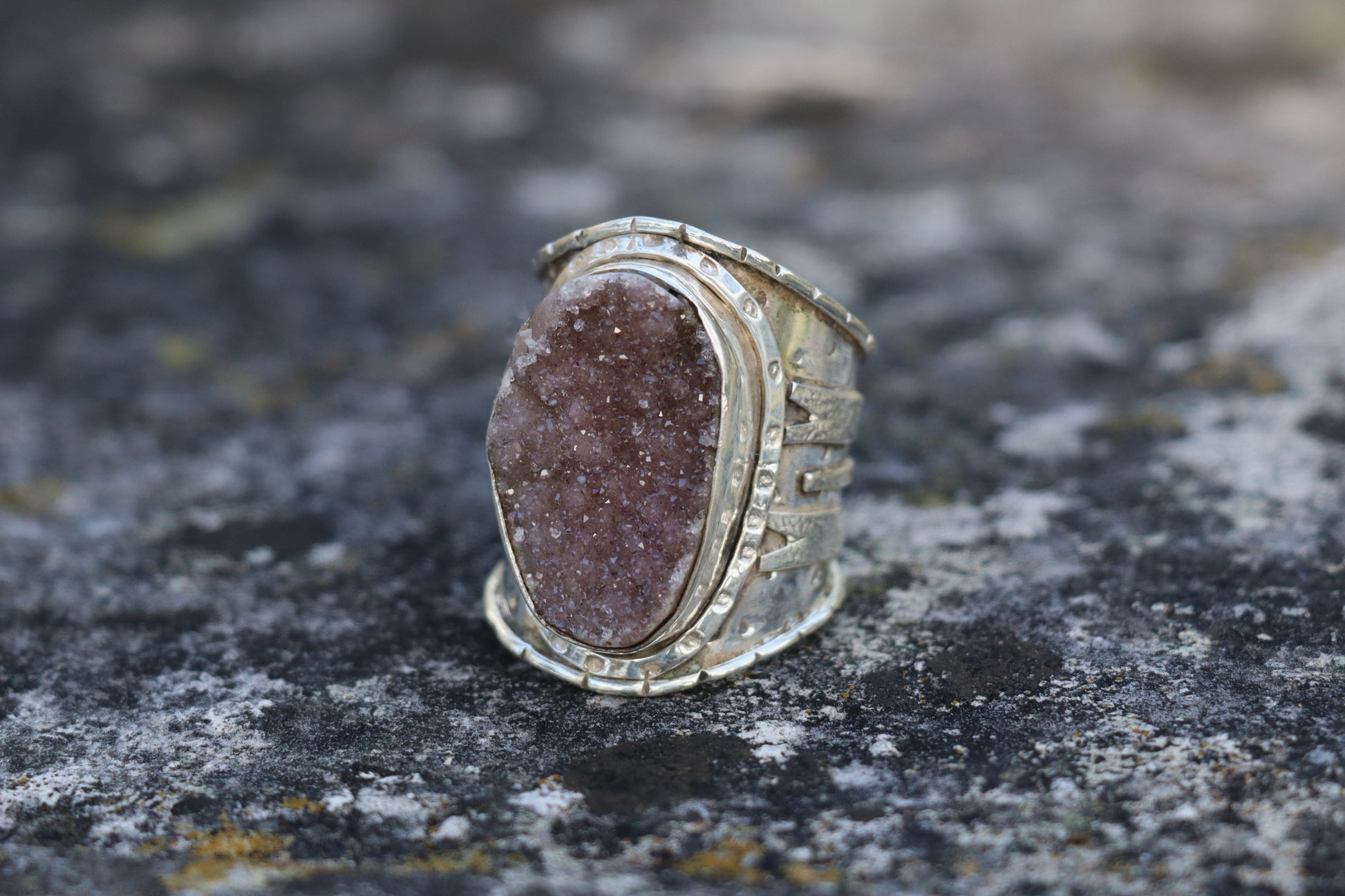 Purple Druzy ring in 925 sterling silver, large natural druzy quartz stone with sparkling violet crystals, handcrafted statement gemstone ring on outdoor stone background.