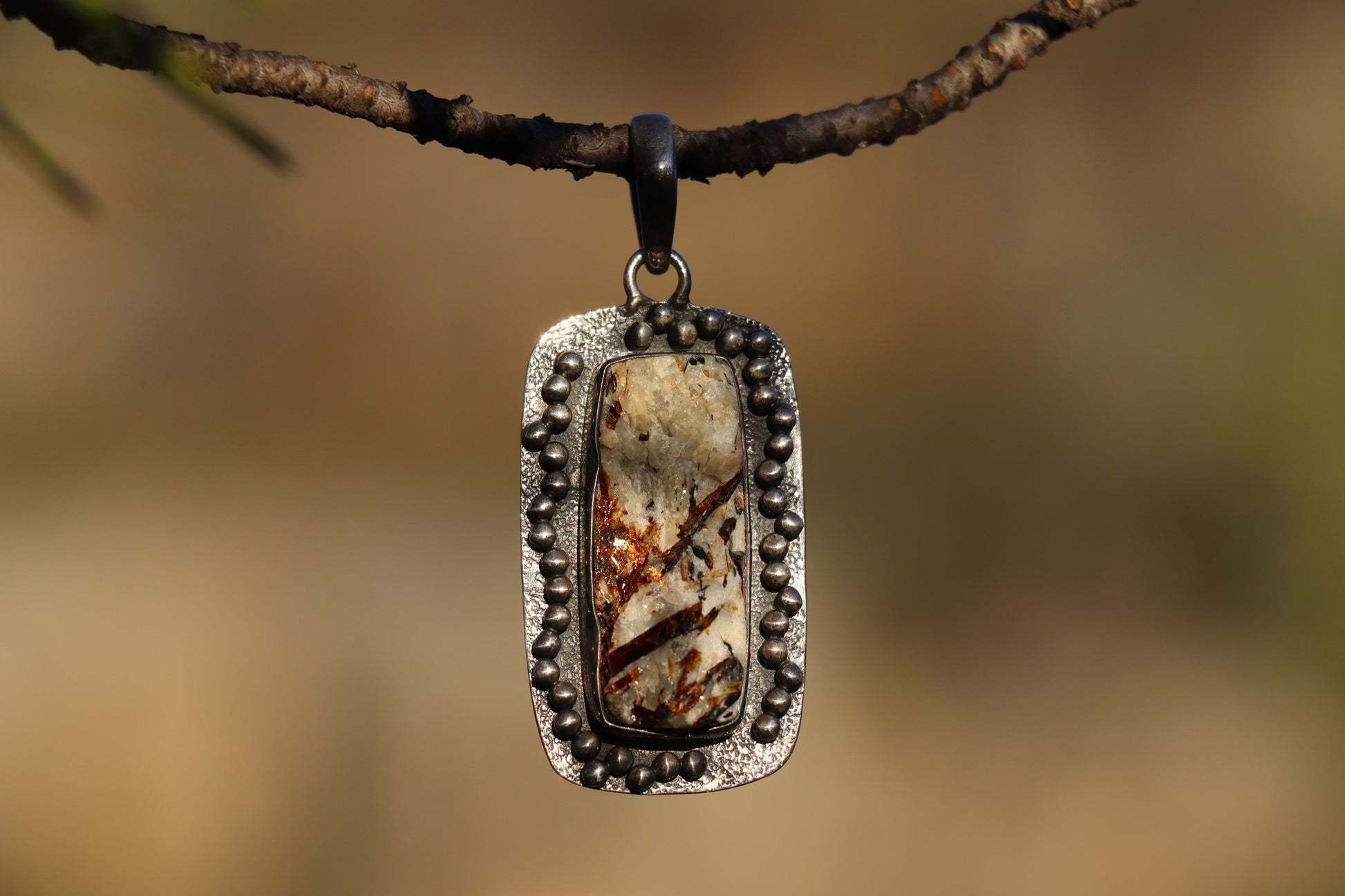 Handcrafted Silver Pendant with Astrophyllite promoting soul remembrance and personal evolution.
