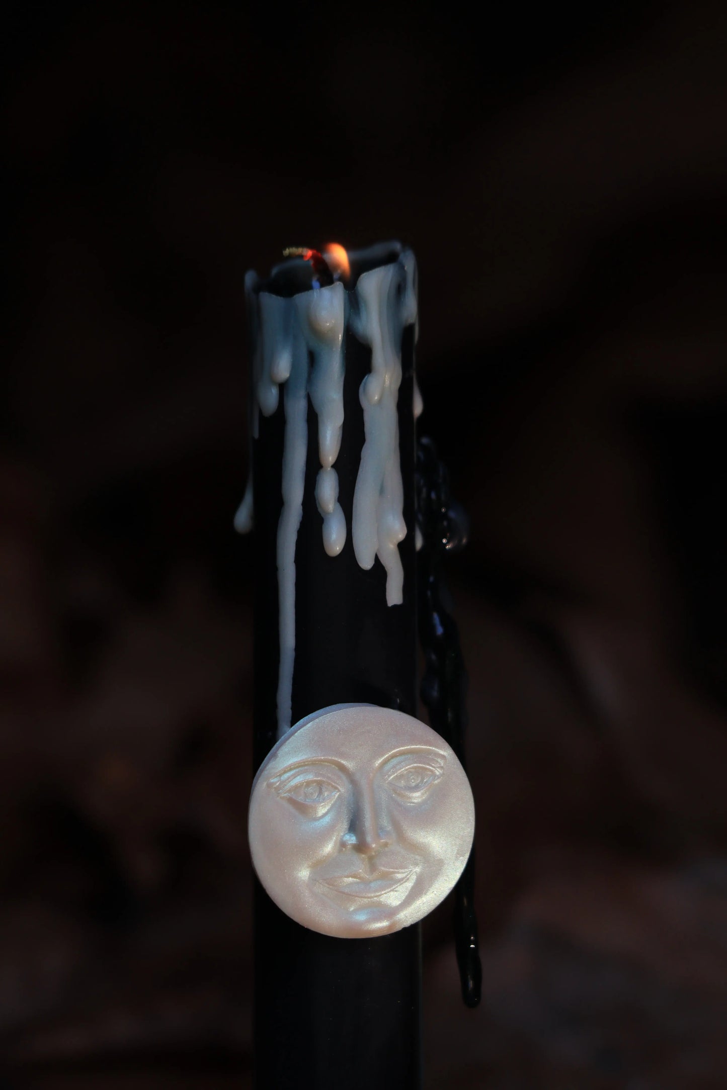 Black New Moon ritual candle burning for manifestation, shadow work, and setting intentions. Artisan ritual candle with dripping wax, designed for lunar deities like Artemis and Selene. Moon magic candle for spiritual ceremonies, meditation, and connecting with lunar cycles and inner intuition.