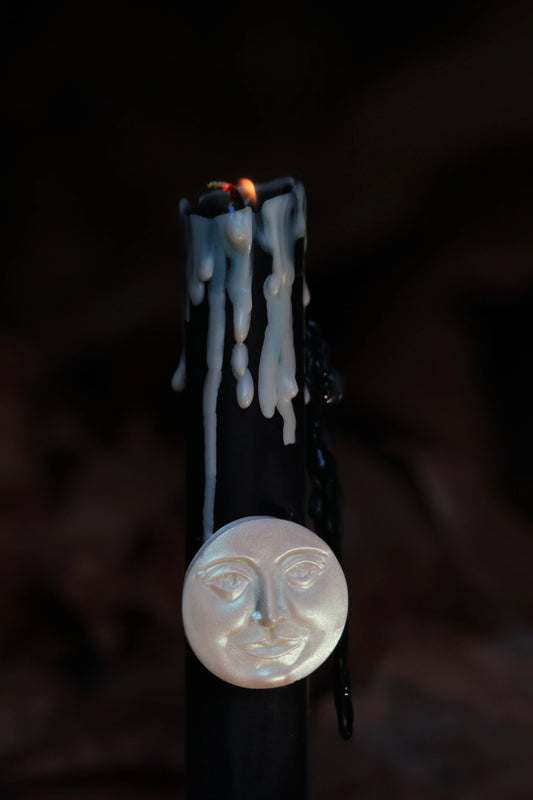 Black New Moon ritual candle burning for manifestation, shadow work, and setting intentions. Artisan ritual candle with dripping wax, designed for lunar deities like Artemis and Selene. Moon magic candle for spiritual ceremonies, meditation, and connecting with lunar cycles and inner intuition.