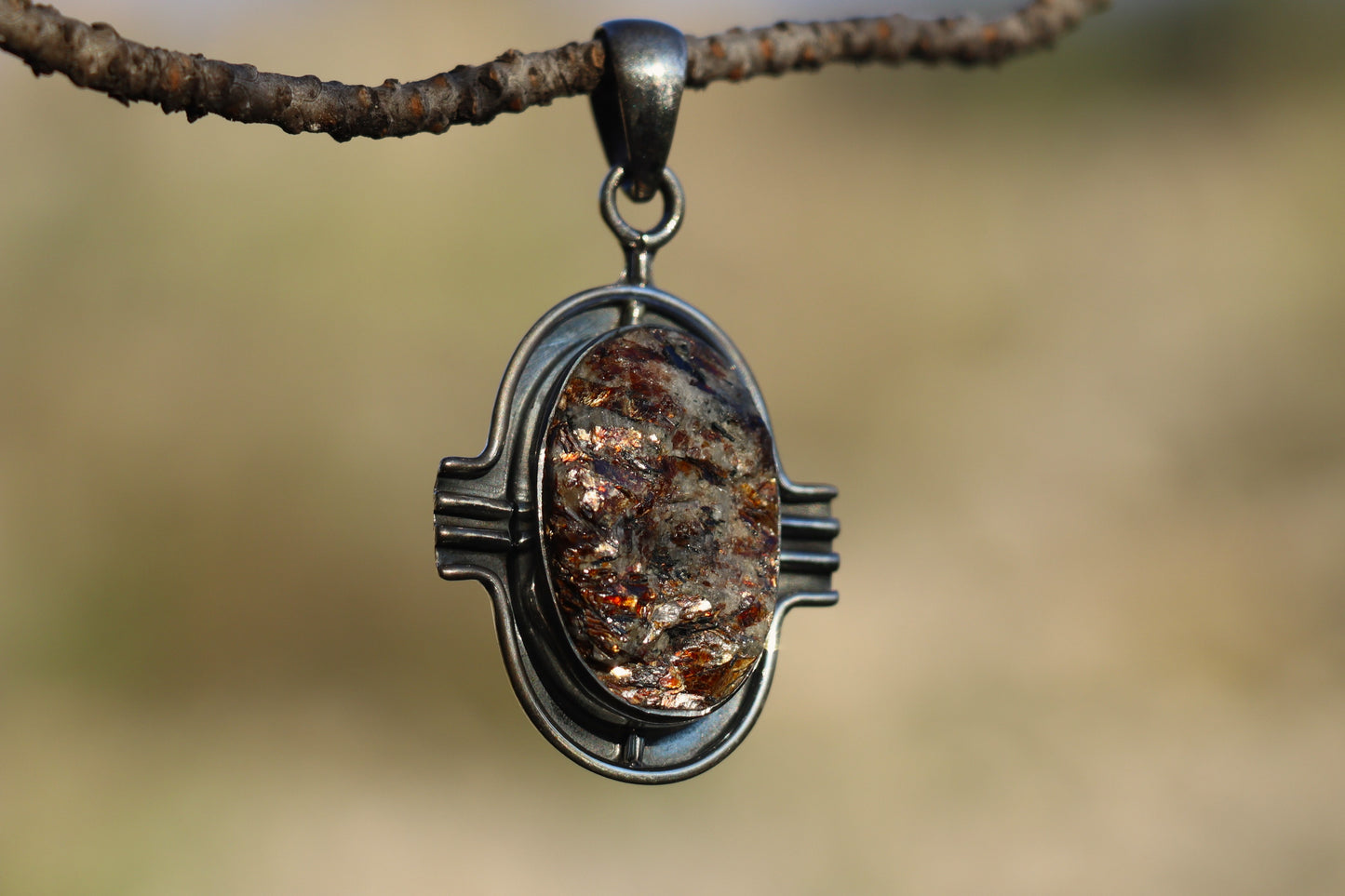 Handcrafted Silver Pendant with Astrophyllite. Witchy jewelry for transformation and rebirth.
